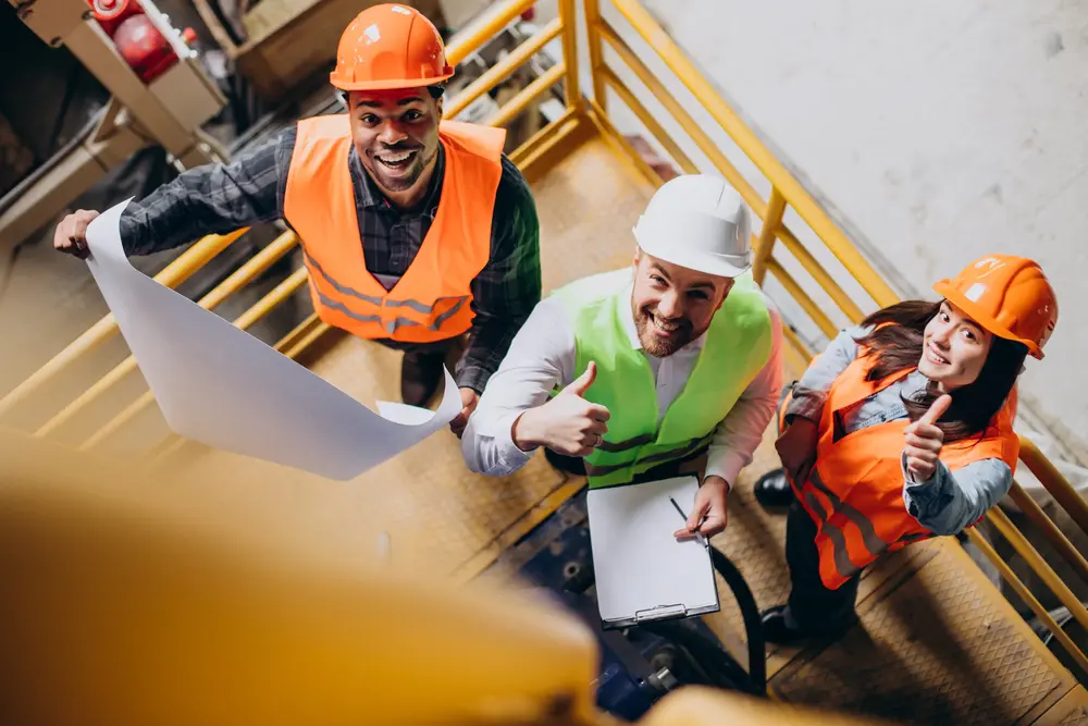 a group of 3 diverse plumbers going over a plan