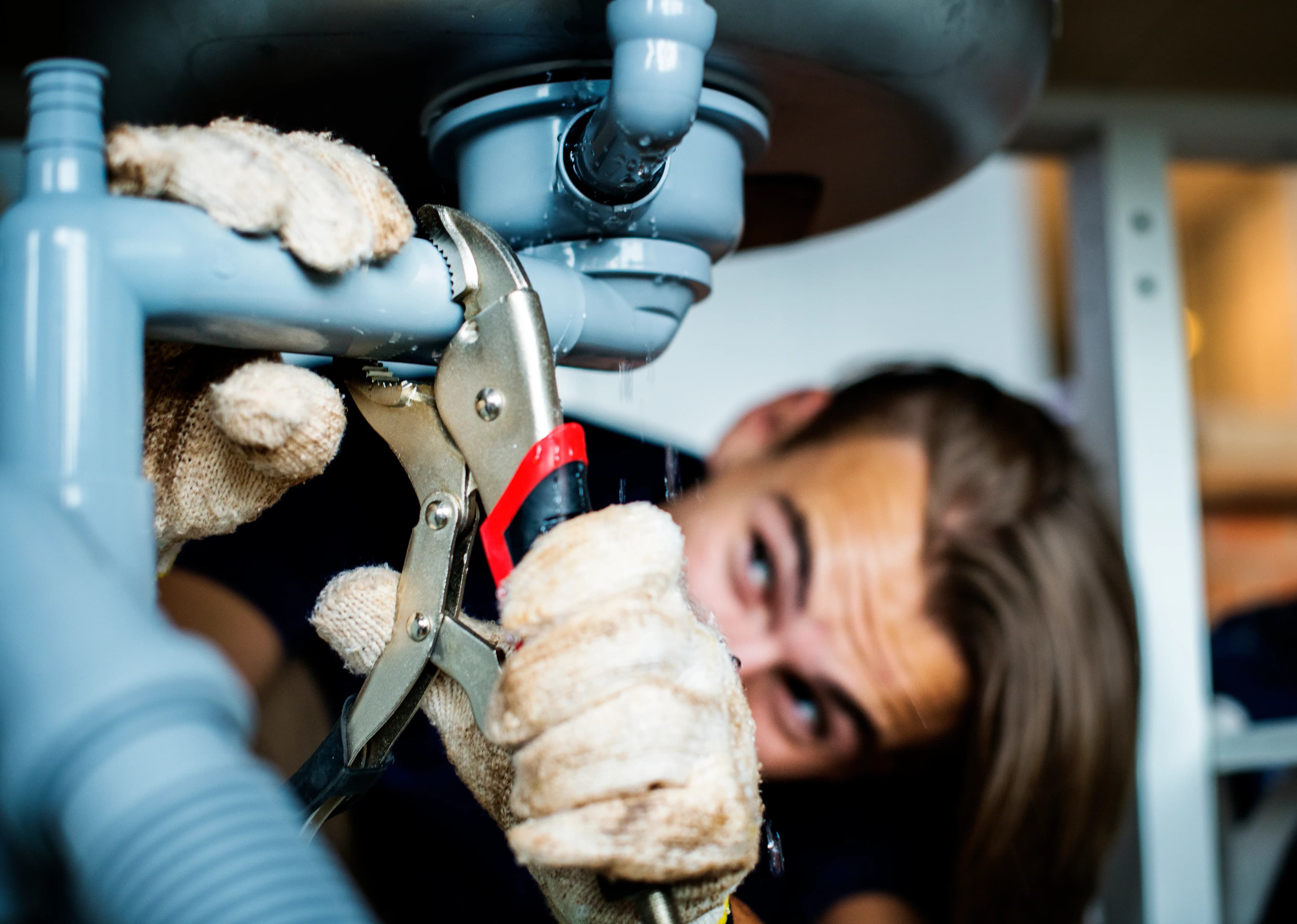 plumber fixing burst pipe